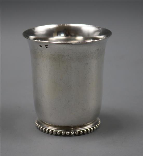 A late 19th/early 20th century French 950 white metal beaker, on beaded foot, 75mm.